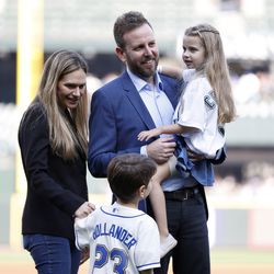 Newly promoted general manager Justin Hollander of the Seattle Mariners looks on with his family before the game