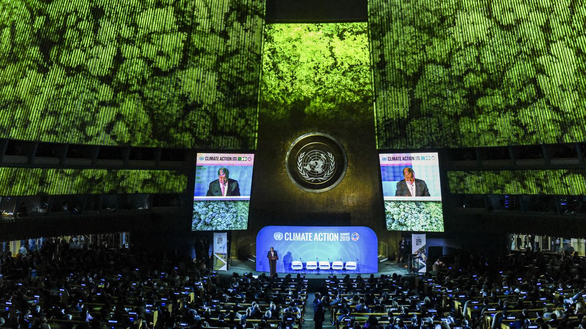 Inside the United Nations Climate Action Summit, where the audience watches two large video monitors flanking UN Secretary-General António Guterres onstage.