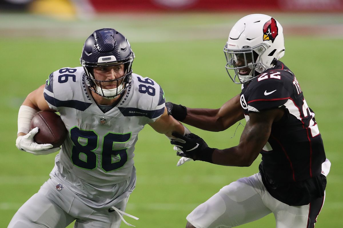 Jacob Hollister #86 of the Seattle Seahawks runs with the football past safety Deionte Thompson #22 of the Arizona Cardinals during the NFL game at State Farm Stadium on October 25, 2020 in Glendale, Arizona. The Cardinals defeated the Seahawks 37-34 in overtime.