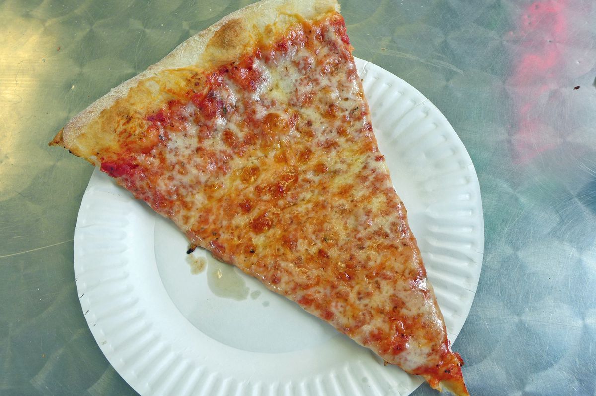 A slice on a plate against a green Formica background.