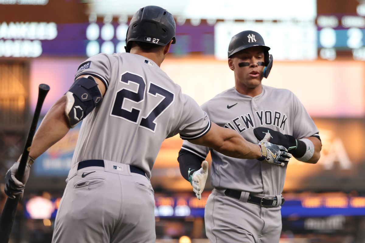 Aaron Judge of the New York Yankees celebrates scoring a fifth inning run with Giancarlo Stanton while playing the Detroit Tigers at Comerica Park on August 28, 2023 in Detroit, Michigan.