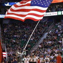 Utah Jazz Bear holds the flag during NBA action in Salt Lake City on Friday, Nov. 4, 2016. The Spurs won 100-86.