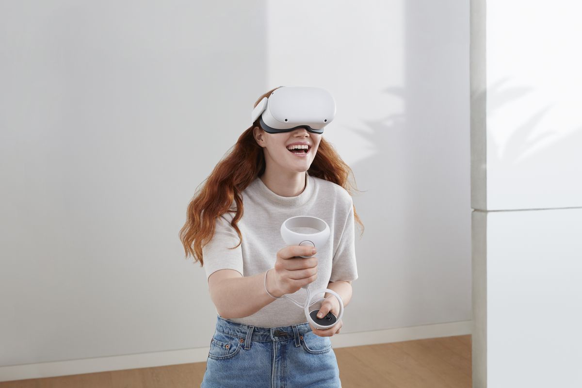 A woman uses Oculus Quest 2 hardware to explore VR