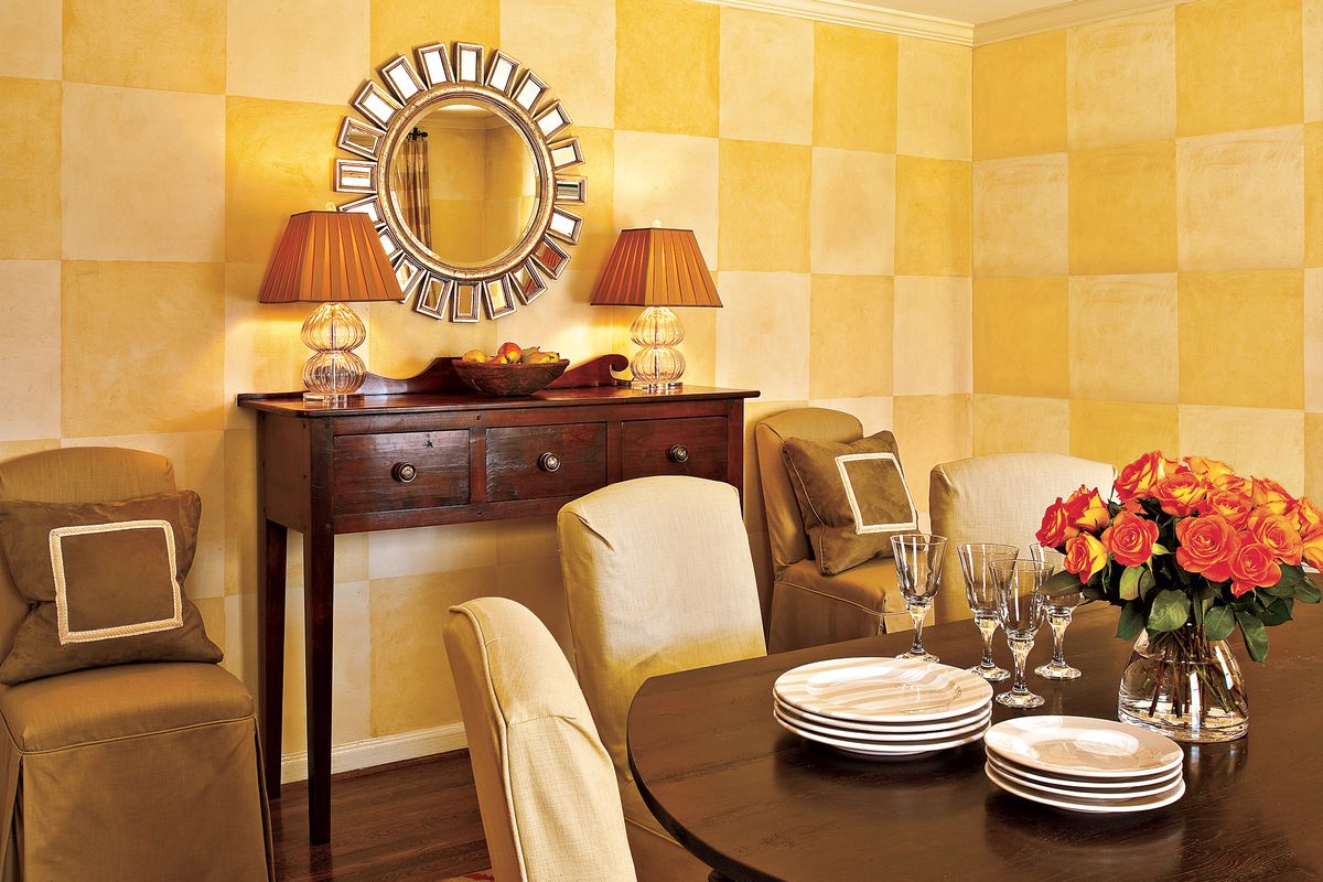 Checkered yellow wall painting in a dining room.
