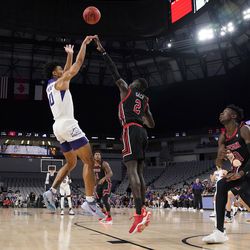 TCU guard Micah Peavy (0) takes as shot as Utah guard Both Gach (2) defends in the first half of an NCAA college basketball game in Fort Worth, Texas, Wednesday, Dec. 8, 2021. 