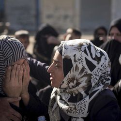 An Iraqi woman comforts a grieving relative at a collection point for displaced citizens of Mosul in this Saturday, Nov. 12, 2016 photo in the Mosul district of Gogjali, Iraq. Residents fleeing the fighting in Mosul say that two years of rule by the Islamic State group crushed a city that was arguably the most multicultural in Iraq with a thriving identity, turning it into a place of darkness and fear. 