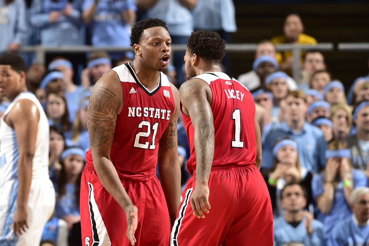Feb 24, 2015; Chapel Hill, NC, USA; North Carolina State Wolfpack forward Beejay Anya (21) and guard Trevor Lacey (1) react in the first half at Dean E. Smith Center. 