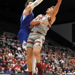 Stanford forward Reid Travis (22) takes a shot over BYU forward Payton Dastrup (15) during the first half of an NCAA college basketball game in the first round of the NIT on Wednesday, March 14, 2018, in Stanford, Calif. (AP Photo/Tony Avelar)