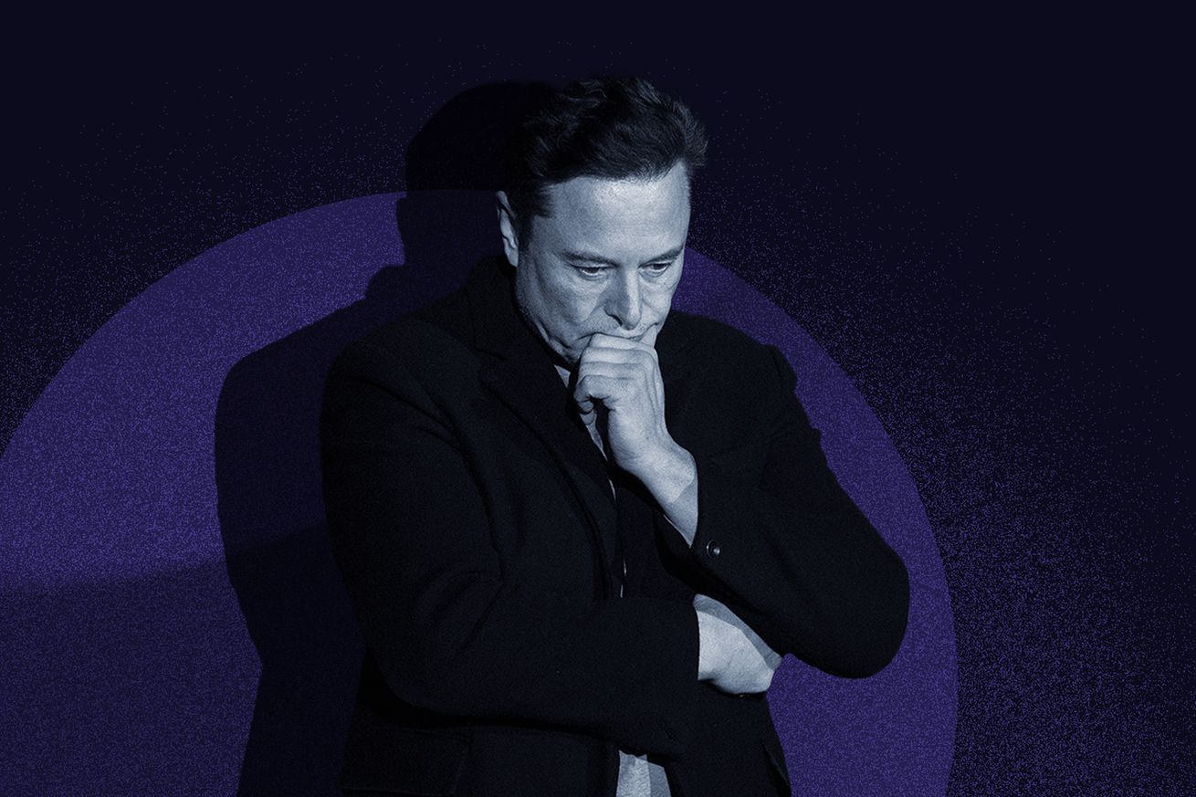 Elon Musk pontificates against a spotlight and blue background