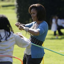FILE - In this Oct. 21, 2009 file photo, first lady Michelle Obama exercises with a hula hoop during a healthy kids fair on the South Lawn of the White House in Washington. What does Michelle Obama do next? After eight years as a high-profile advocate against childhood obesity, a sought-after talk show guest, a Democratic power player and a style maven, the first lady will have her pick of options when she leaves the White House next month. 