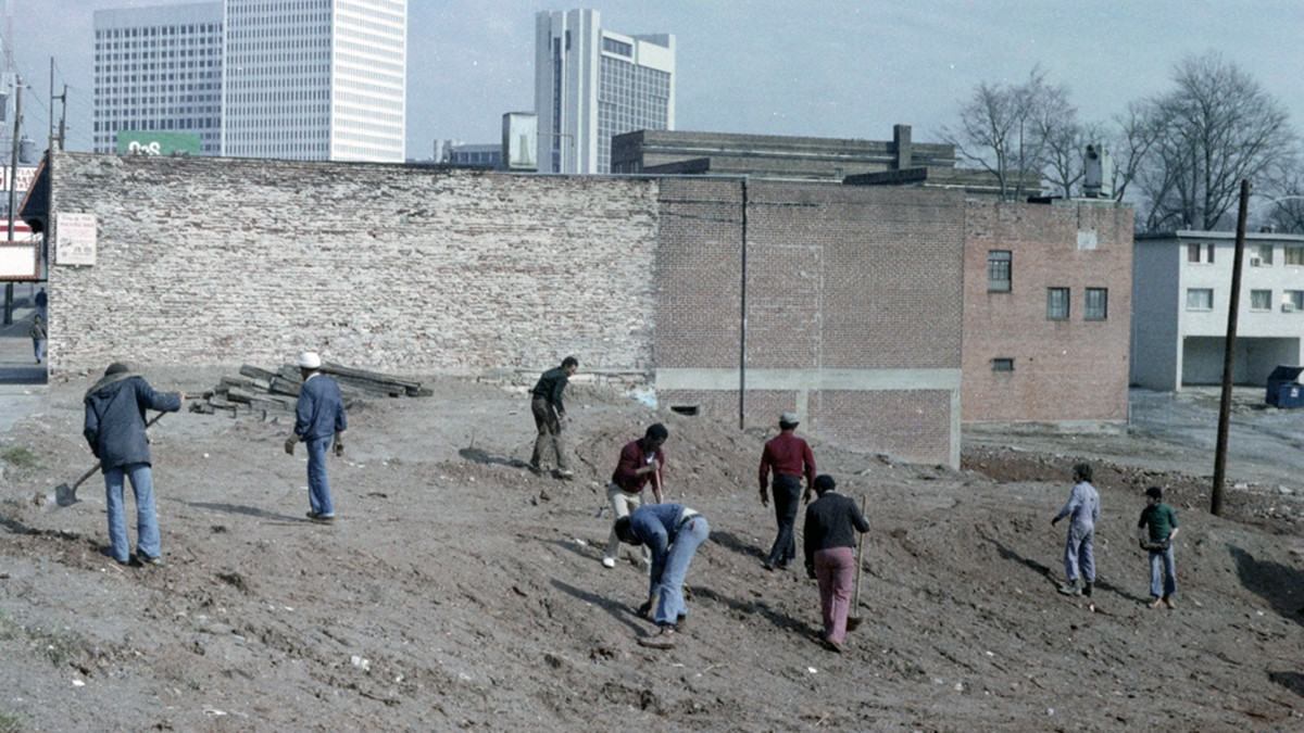 A group of people cleaning a dirty area in Midtown Atlanta in 1970s.