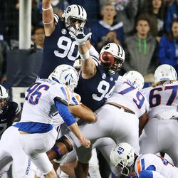Brigham Young Cougars defensive lineman Kesni Tausinga (94) and Brigham Young Cougars defensive lineman Corbin Kaufusi (90) try to block a field goal by Boise in Provo on Friday, Oct. 6, 2017.