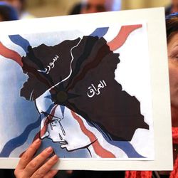 An Iraqi Assyrian woman who fled from Mosul to Lebanon holds a placard depicting the map of Iraq and Syria, during a sit-in for abducted Christians in Syria and Iraq, at a church in Sabtiyesh area east Beirut, Lebanon, Thursday, Feb. 26, 2015. Islamic State militants snatched more hostages from homes in northeastern Syria over the past three days, bringing the total number of Christians abducted to over 220 in the one the largest hostage-takings by the extremist group, activists said Thursday. 