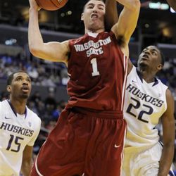 FILE: This March 10, 2011, file photo shows Washington State's Klay Thompson, center, putting up a shot between Washington's Scott Suggs, left, and Justin Holiday during the first half of an NCAA college basketball game at the Pac-10 tournament, in Los Angeles.