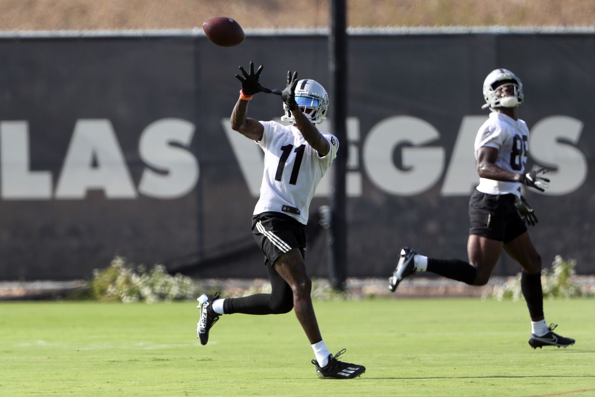 Henry Ruggs III #11 of the Las Vegas Raiders catches a pass during training camp at the Las Vegas Raiders Headquarters/Intermountain Healthcare Performance Center on July 29, 2021 in Henderson, Nevada. Bryan Edwards #89 is at right.