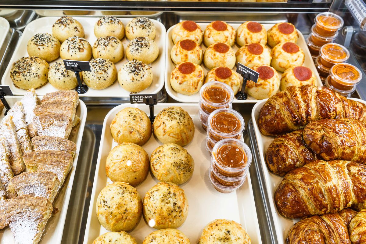 Trays of savory breads in a display case inside Milk Bar