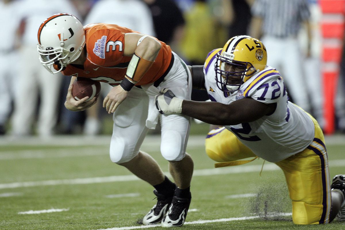Miami's #3 Kyle Wright is sacked by Louisiana State's #72 Glenn Dorsey during the Tigers win over Miami on December 30, 2005
