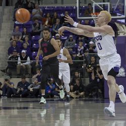 Jaylen Fisher passes the ball ahead on a fast break.