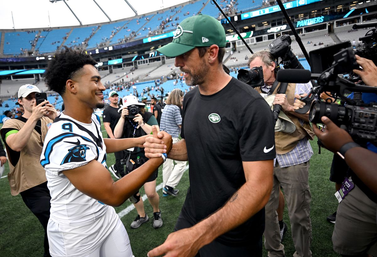 Rodgers shaking hands with Bryce Young the new quaterback for the Carolina Panthers