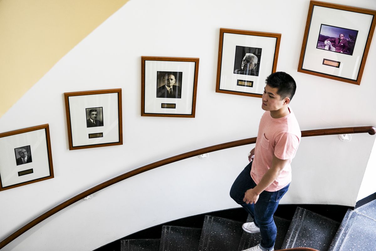 Junior Eric Cheng walks past portraits of former Economics professors in the Harvard University Department of Economics, on April 24, 2019.