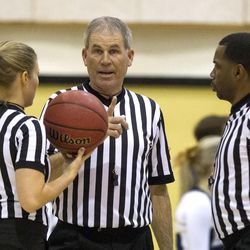Official Ken Sowby, center, Angel Kent, left, and Kenny Johnson discuss a play during a UHSAA basketball game between Brighton and Skyline in Salt Lake City on Wednesday, Dec. 7, 2016.