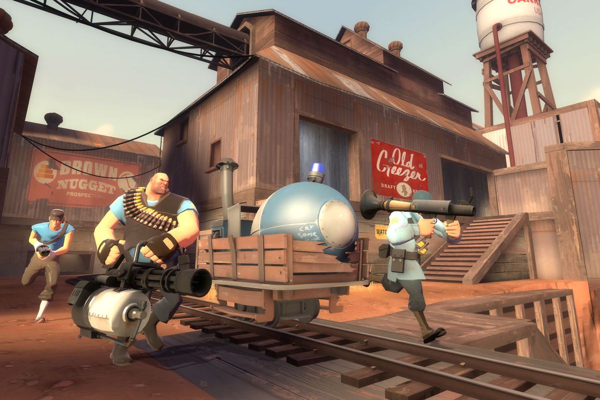 BLU Scout, Heavy, and Soldier move a payload in a screenshot from Team Fortress 2