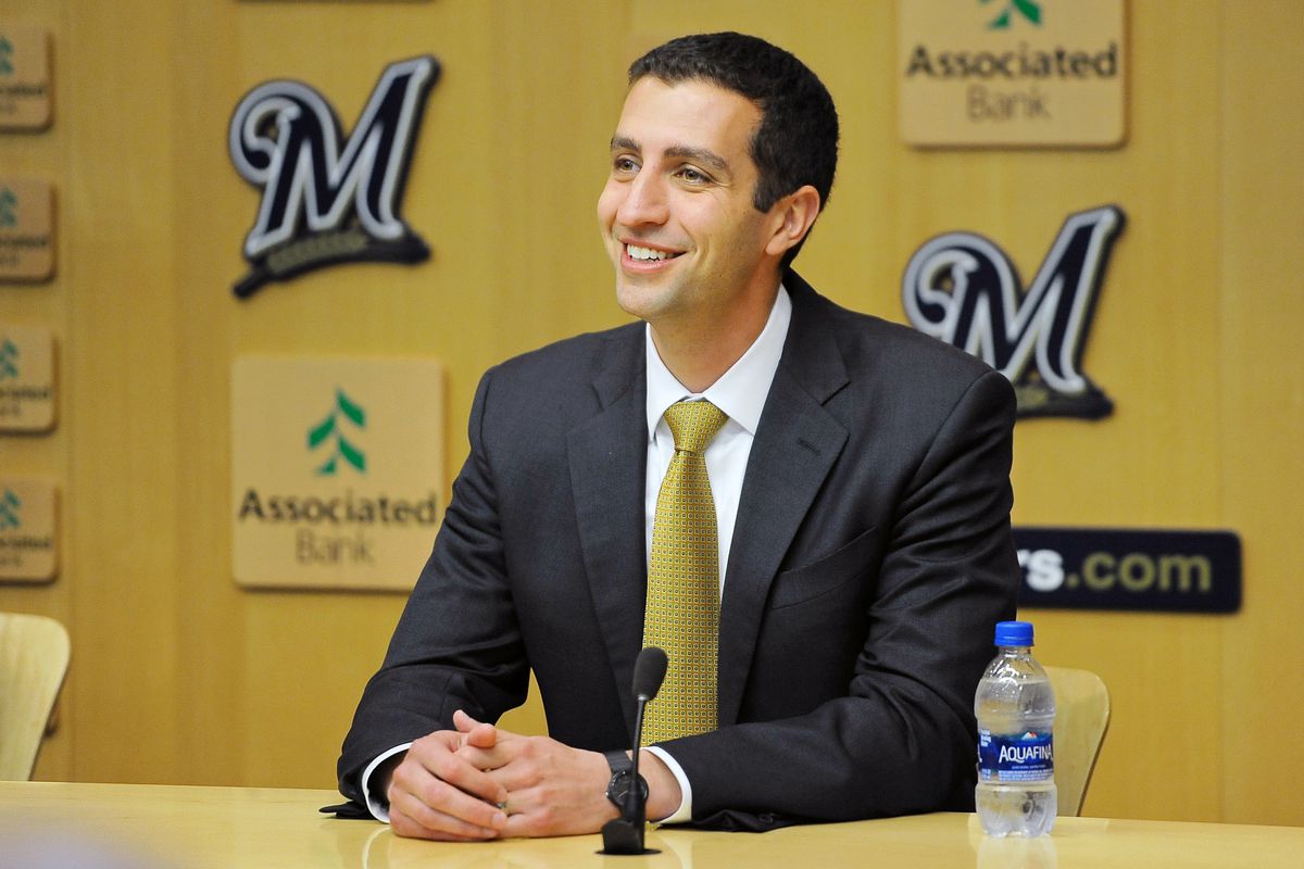 A photo of David Stearns wearing a suit, sitting in front of a microphone.