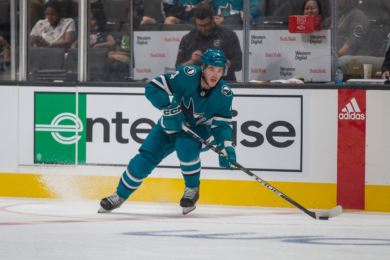 San Jose Sharks defenseman Scott Harrington (4) passes the puck during the second period of a preseason NHL hockey game against the Los Angeles Kings on September 25, 2022, at SAP Center, in San Jose, CA.