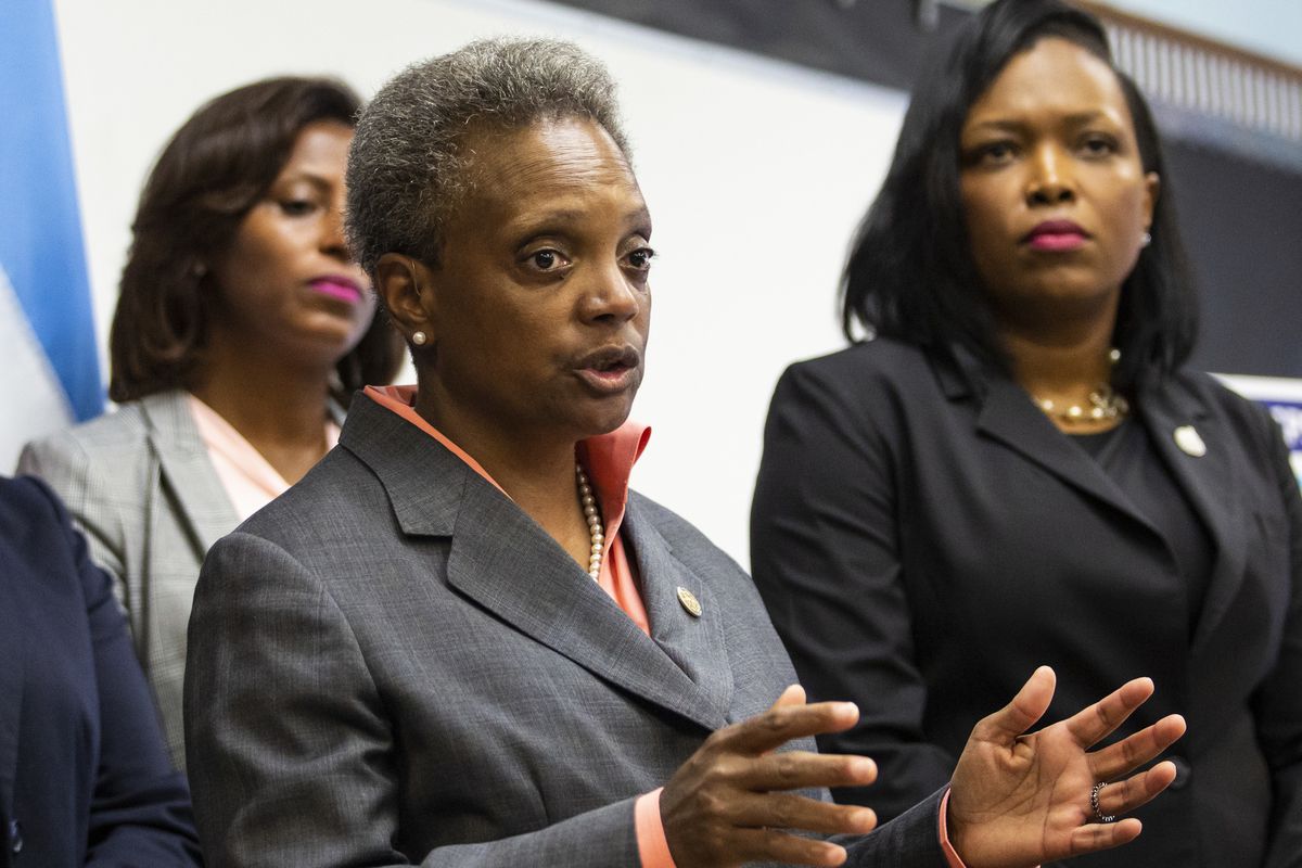 Chicago Public Schools Chief Education Officer LaTanya McDade (left) and CEO Janice Jackson (right) join Mayor Lori Lightfoot as she speaks about the Chicago Teachers Union contract in August.