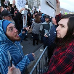 Martin Gassner and Cameron Ashby debate their views as Trump supporters and Trump protesters clash outside of the Infinity Event Center where Donald Trump is holding a rally in Salt Lake City Friday, March 18, 2016. The conversation ended amicably.