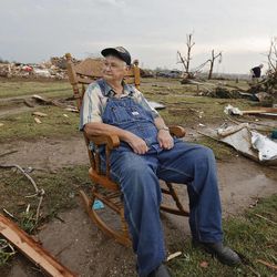 Gene Tripp sits in his rocking chair where his home once stood after being destroyed by a tornado hit the area near 149th and Drexel on Monday, May 20, 2013 in Oklahoma City, Okla.  