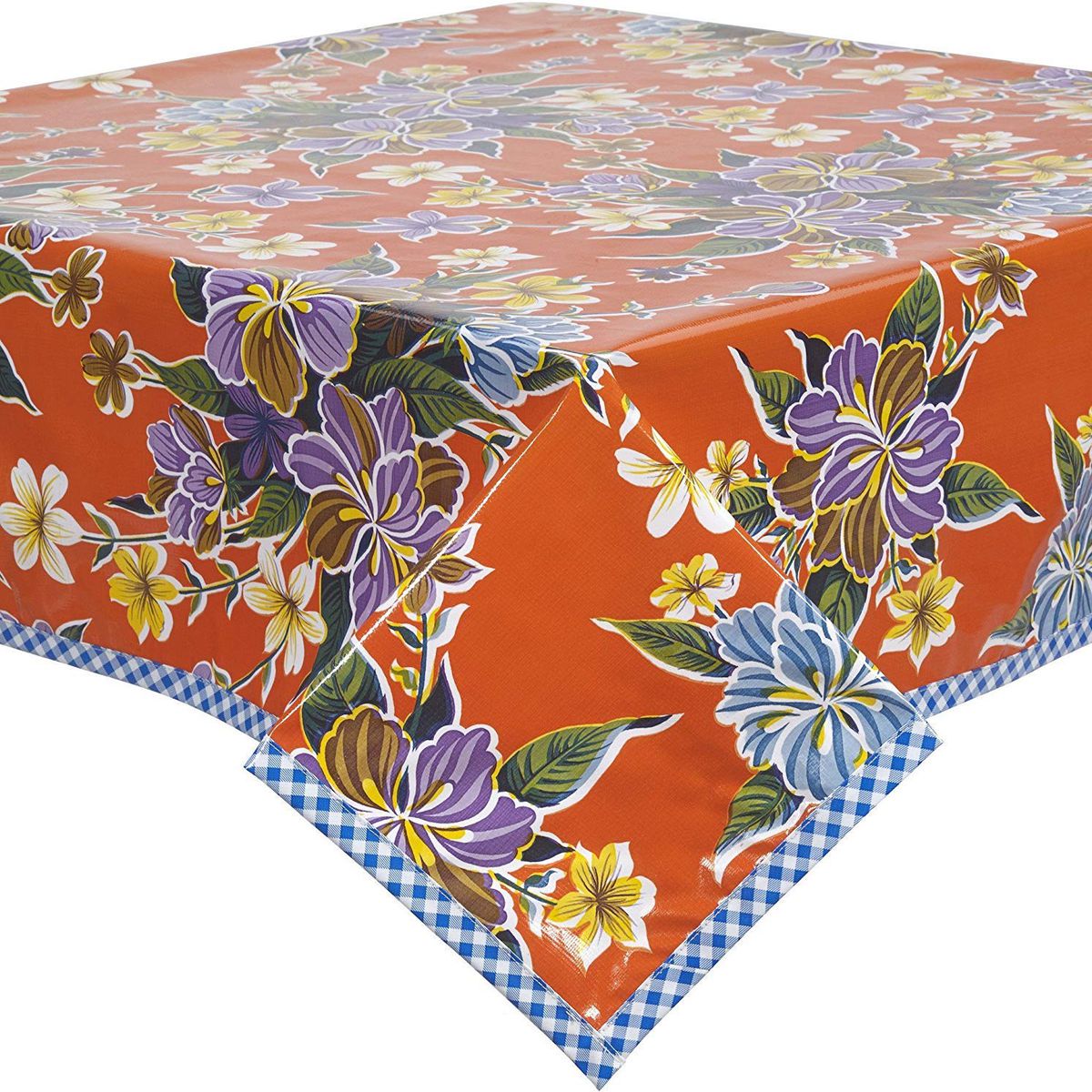 An orange floral oilcloth tablecloth with gingham trim