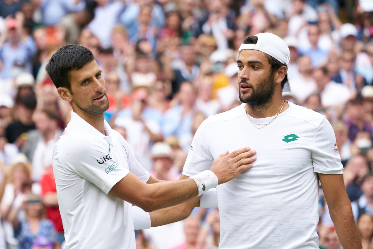 Novak Djokovic (SRB) at the net with Matteo Berrettini (ITA) after winning the mens final on Centre Court at All England Lawn Tennis and Croquet Club.