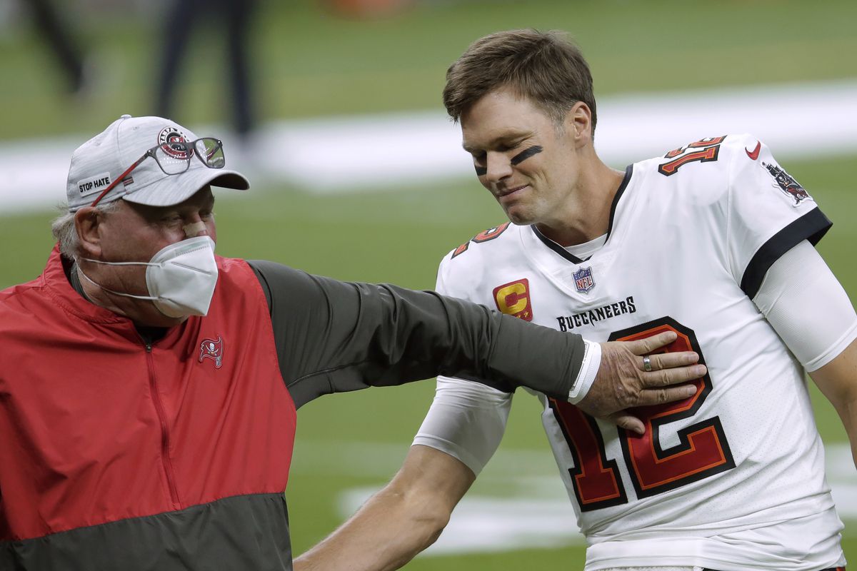 In this Jan. 17, 2021, file photo, Tampa Bay Buccaneers coach Bruce Arians, left, speaks with quarterback Tom Brady before the team’s NFL divisional round playoff football game against the New Orleans Saints in New Orleans. Dr. Anthony Fauci wanted to remind everyone to watch the Super Bowl with their family.