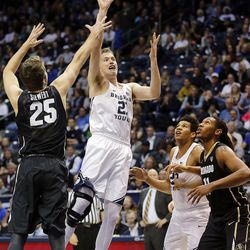 Brigham Young Cougars forward Kyle Davis (21) takes a shot with Colorado Buffaloes forward Lucas Siewert (25) defending during an NCAA basketball game against Colorado in Provo on Saturday, Dec. 10, 2016.