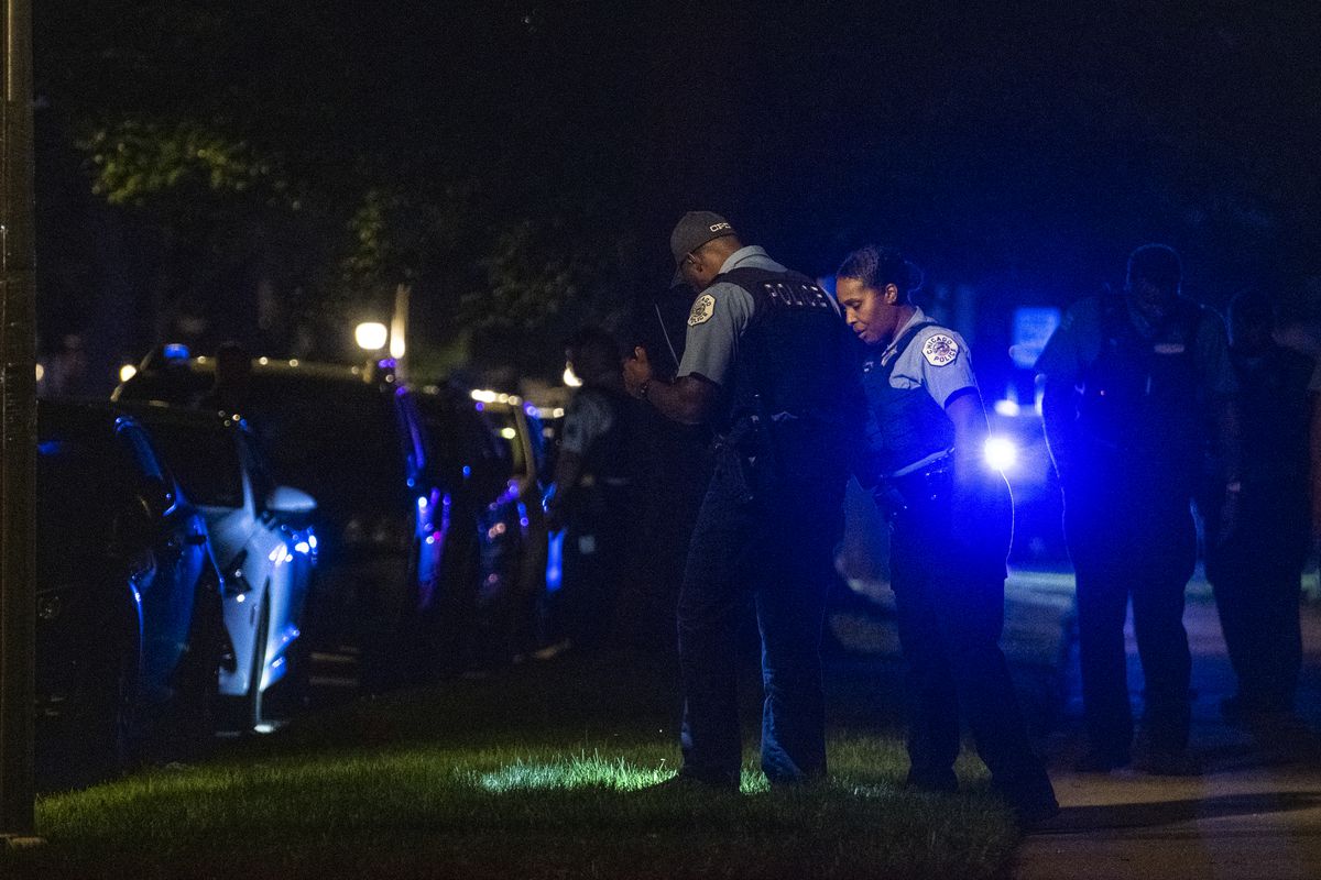 Chicago police work the scene where two people were shot in the 7600 block of South Saint Lawrence Avenue, in the Chatham neighborhood, Saturday, July 17, 2021. 