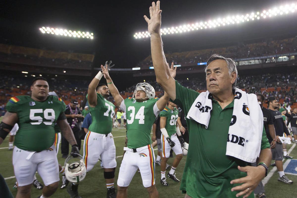 Hawaii coach Norm Chow, right, waves to fans after Hawaii's 49-42 win over Army in an NCAA college football game Saturday, Nov. 30, 2013, in Honolulu.
