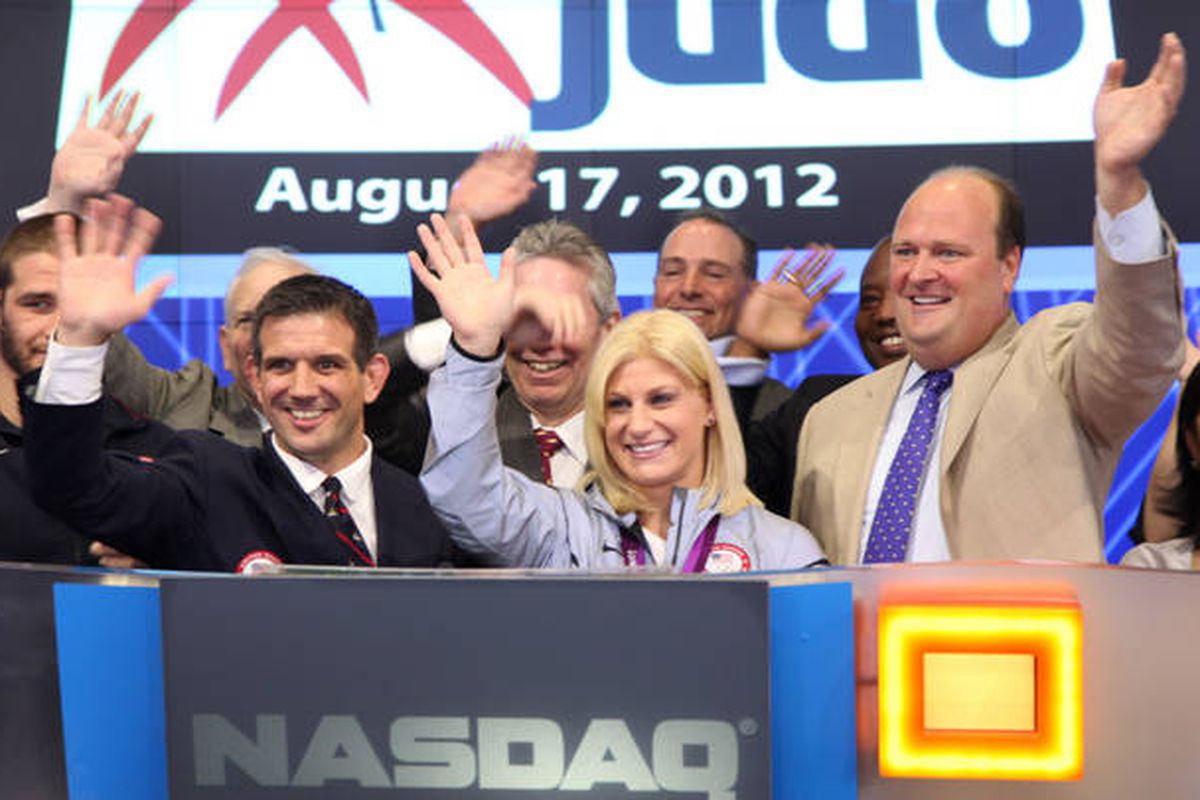 Kayla Harrison (center), Olympic champion, judo 78-kilograms, rings the opening bell at NASDAQ on Friday, August 17. Her coach and U.S. Olympic coach Jimmy Pedro is on the left. Photo courtesy of NASDAQ.