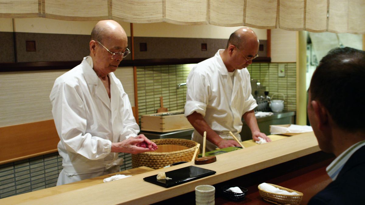 Behind the counter, Ono handles a cut of fish.