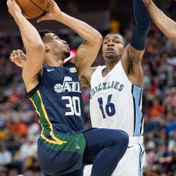 The Utah Jazz's Naz Mitrou-Long drives to the hoop against the Memphis Grizzlies' Brandon Goodwin during a Summer League game at Vivint Smart Home Arena in Salt Lake City on Tuesday, July 3, 2018.