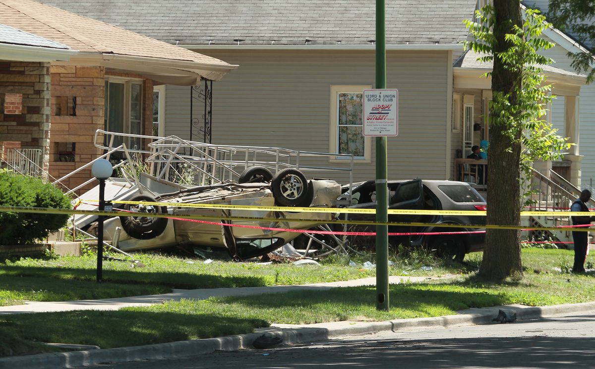 Police investigate a car crash at the corner of 123rd and Union. | Leslie Adkins/For the Sun-Times