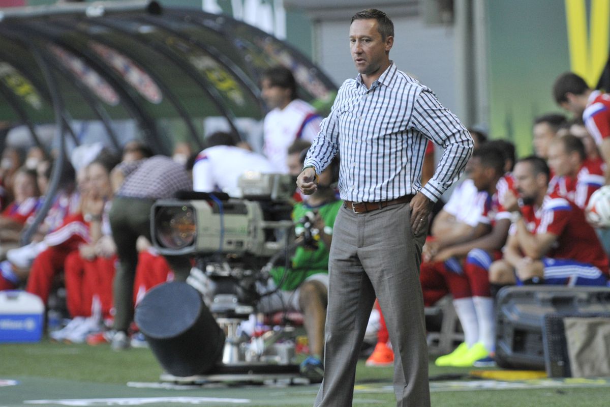 Caleb Porter in front of the All-Stars bench during the All-Star game.