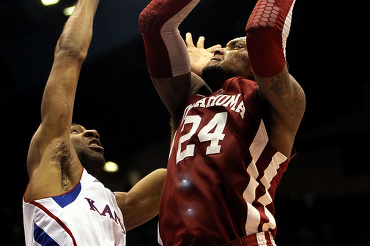 LAWRENCE, KS - FEBRUARY 01:  Romero Osby #24 of the Oklahoma Sooners shoots over Justin Wesley #4 of the Kansas Jayhawks tries to block during the game on February 1, 2012 at Allen Fieldhouse in Lawrence, Kansas.  (Photo by Jamie Squire/Getty Images)