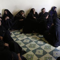 Women mourn over Egyptian Coptic Christians who were captured in Libya and killed by militants affiliated with the Islamic State group, inside the Virgin Mary Church in the village of el-Aour, near Minya, 220 kilometers (135 miles) south of Cairo, Egypt, Monday, Feb. 16, 2015. Egyptian warplanes struck Islamic State targets in Libya on Monday in swift retribution for the extremists' beheading of a group of Egyptian Christian hostages on a beach, shown in a grisly online video released hours earlier. 
