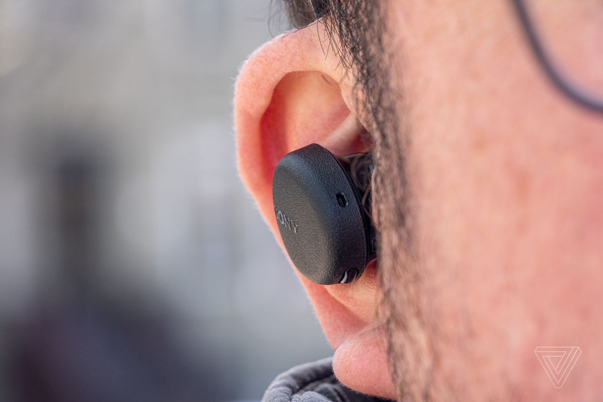 An image of the Sony WF-XB700, the best wireless earbuds for around $100, in someone’s ear.