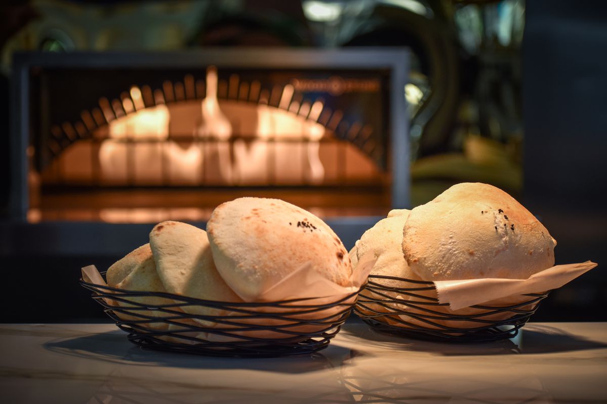 Pita bread on a table in a basket.