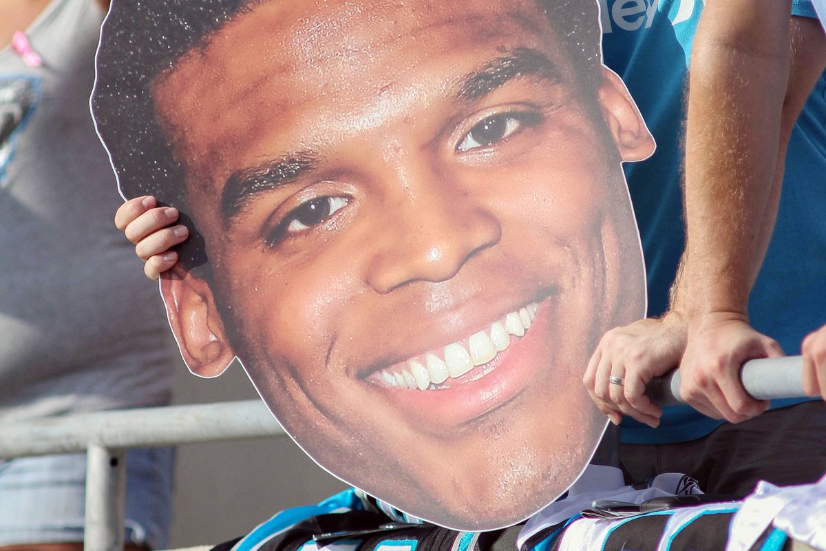Jul 28, 2012; Spartanburg, SC USA. A Carolina Panthers fan holds up a giant Cam Newton head during the training camp held at Wofford College. Mandatory Credit: Jeremy Brevard-US PRESSWIRE