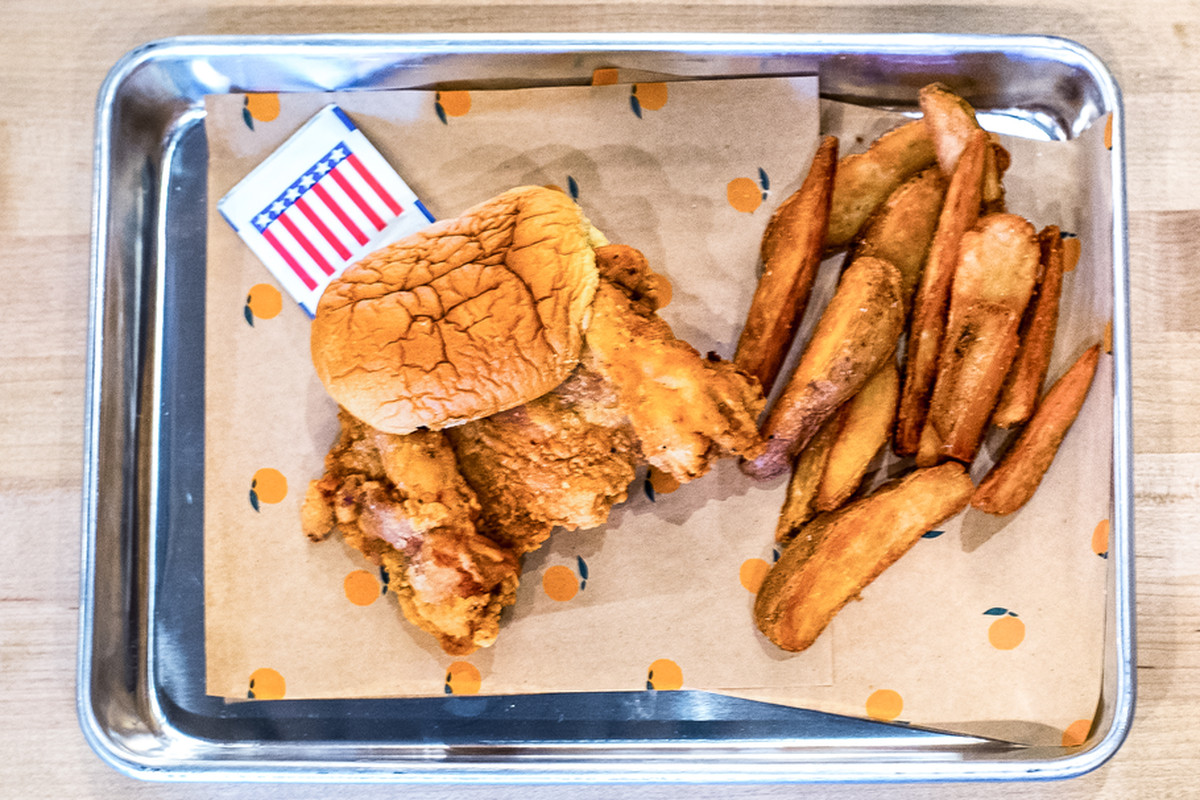 Fried chicken sandwich and fries at Fuku.