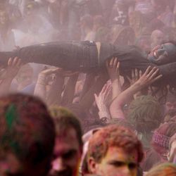 Body surfing after the throw as thousands turn out Saturday, March 26, 2011, for the Holi Festival of Colors at the Krishna Temple in Spanish Fork. 