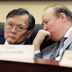 Sen. Brian Shiozawa, R-Cottonwood Heights, left, and Sen. Jim Dabakis, D-Salt Lake City, confer during a discussion on HB154 at the Capitol in Salt Lake City on Monday, Feb. 13, 2017. The bill would would bar doctors from using telemedicine to remotely prescribe abortion-inducing medication.